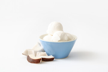 Fototapeta na wymiar Bowl with tasty coconut ice cream on white background
