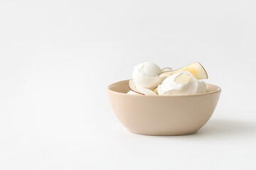 Bowl with tasty coconut ice cream on white background