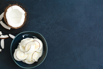 Bowl with tasty coconut ice cream on dark background