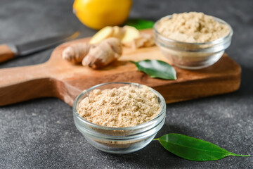 Composition with ginger powder on dark background, closeup