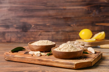 Composition with ginger powder on wooden background