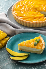 Plate with piece of tasty mango pie on color background