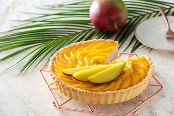 Tasty mango pie on light background