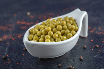 Pile of green marinated olives in white ceramic bowl