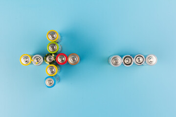 Photo of alkaline batteries on blue background. Recycling of rechargeable NiMH batteries. The...