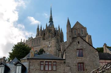 Obraz premium A crowd of tourists on Grand Rue, the main street in Mont Saint Michele. Normandy, France