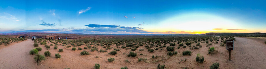 The Horseshoe Bend at dawn. Countryside and red sand - Panoramic view