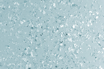 pearl confetti sparkles on blue holiday background. Festive backdrop or greeting card for designers.