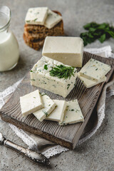 Homemade sheep, goat, or cow cheese with herbs. Farm dairy products. Eco-friendly healthy high-protein food.