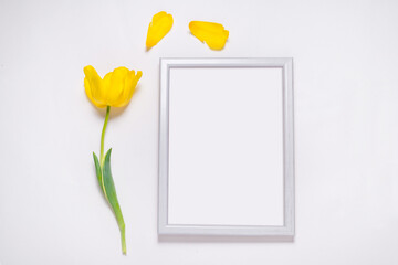 Photo frame decorated with fresh yellow tulips