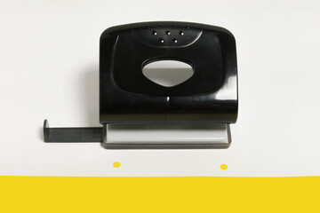 black office hole puncher on a paper