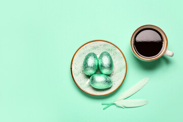 Plate with sweet chocolate eggs and cup of coffee on color background