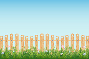 Wooden fence with grass, flowers and blue sky