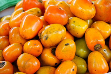 Colorful persimmons in a small market at Vietnam.