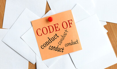 Code Of Conduct. the text on the sticker on the table.