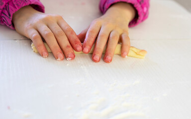 little chef twirls cherries into dough for sweet pie, horizontal