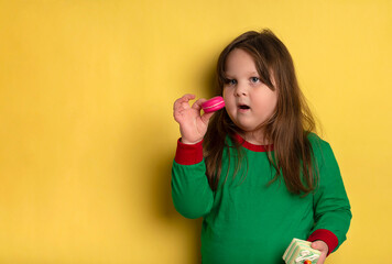 Cute little obese girl of 3-4 years who loves cakes