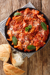 Trippa alla Romana Roman Style tripe with tomato sauce closeup in the plate on the table. Vertical...