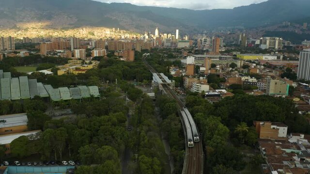 Two Metro Trains Cross Paths in Colombian City of Medellin. Aerial View