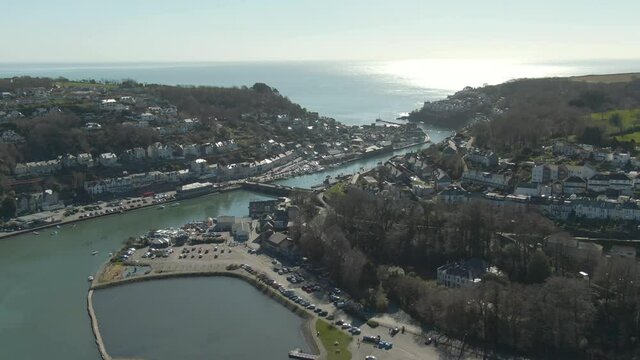 Aerial of Looe town, pointing out to sea. West looe car park and mill pool in the foreground. Famous tourist destination and fishing town