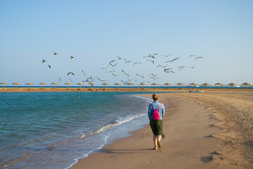 Sunset on the beach with parasol overlooking the Red Sea in Hurghada, Egypt © Tatiana