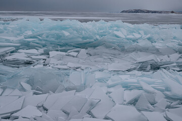 Cracked ice floes on the shore of Baikal. Beautiful landscape concept © Polina