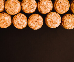Corks from bottles of wine or champagne on a black background. Traffic jams stand in dense rows.Background and texture.
