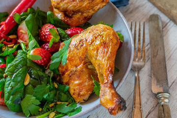 Roasted chicken with spicy spinach strawberry salad