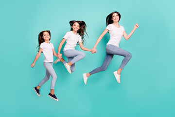 Fototapeta na wymiar Full length body size side profile photo funky cool sisters jumping up running fast isolated vivid blue color background
