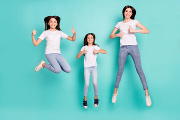 Fototapeta na wymiar Full length body size photo sisters jumping showing thumb-up like gesture isolated bright blue color background