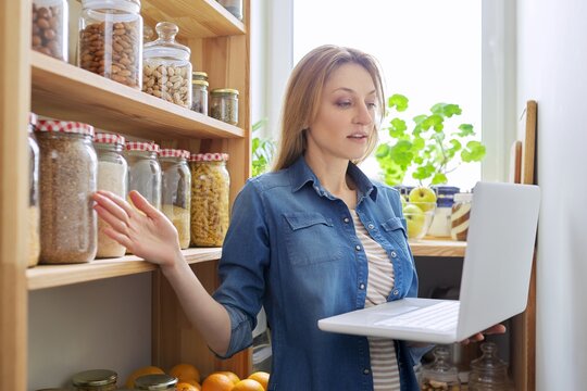 Woman In Home Kitchen Pantry, Holding Laptop, Food Blog, Online Nutritionist Consultation