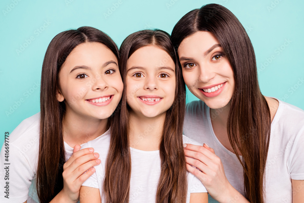 Sticker photo of pretty sweet three siblings wear white t-shirts smiling embracing isolated teal color backg