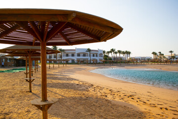 Sunset on the beach with parasol overlooking the Red Sea in Hurghada, Egypt