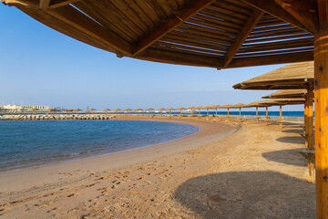 Sunset on the beach with parasol overlooking the Red Sea in Hurghada, Egypt