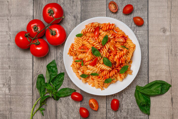 Italian pasta on plate on grey wooden background 