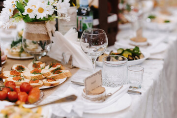glasses for wine and drinks on the laid festive table in the restaurant