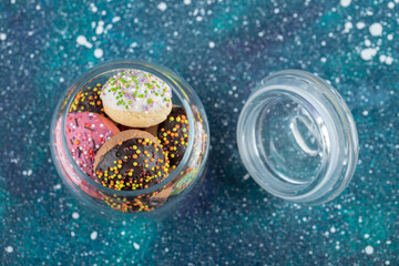 Colorful biscuits decorated with sprinkles in glass jar