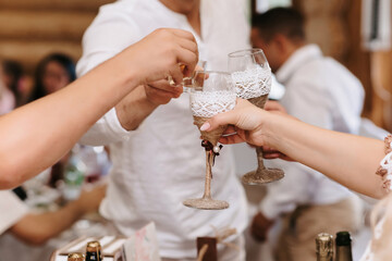 hands of people toasting and clinking glasses at a celebration