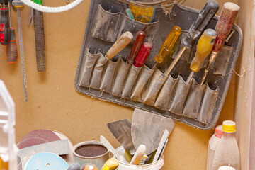 Toolkit full of screwdrivers hangs on the wall in the workshop