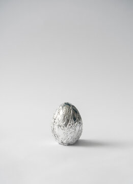 2021 Easter Unique And Real Still Life Composition. Egg In Aluminum Foil. Space Travel And Food Concept Background.