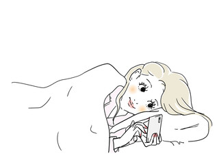 ベッドでスマホに夢中な女性