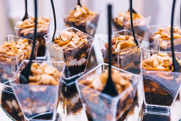 luxury wedding catering, table with modern desserts, cupcakes, sweets with fruits. delicious candy bar at expensive wedding reception.