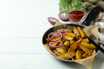 Concept of tasty meal with pan of tasty potato wedges