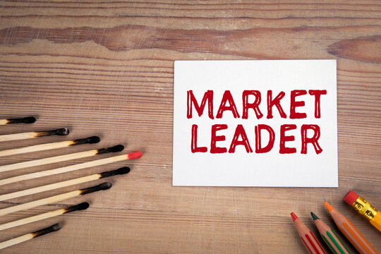 Market Leader. Burnt matches and pencils on a wooden table