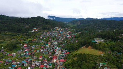 Aerial view town of Sagada, located in the mountainous province of Philippines. City in the valley among the mountains covered with forest. Sagada-Cordillera region-Luzon island.