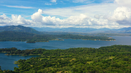 Naklejka premium Landscape with beautiful lake against blue sky and clouds.Mountain landscape in the tropics. Pantabangan lake, Philippines, Luzon.