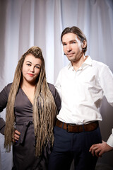 A funny couple of a thin young man and a plump girl with long pigtails. Boy and Girl in love