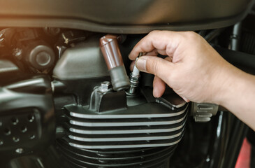 Mechanic Check motorcycle Spark Plug and Maintenance, inspection Prior to Installation in engine...