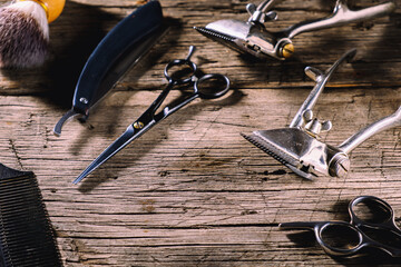 old barber tools on rustic wooden weathered background