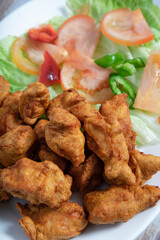 Indian traditional chicken pakora isolated. Vertical picture
